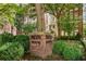 Classic brick building entrance marked by lush landscaping and a decorative sign, offering a welcoming arrival at 1325 Peachtree Ne St # 401, Atlanta, GA 30309