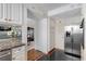 Bright kitchen with stainless steel refrigerator and white cabinets with gold hardware at 1325 Peachtree Ne St # 401, Atlanta, GA 30309