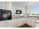 Well-lit kitchen with white cabinetry, granite countertops, and stainless steel appliances at 1325 Peachtree Ne St # 401, Atlanta, GA 30309