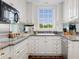 Well-lit kitchen with white cabinetry, granite countertops, and stainless steel appliances at 1325 Peachtree Ne St # 401, Atlanta, GA 30309