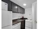 Compact kitchenette with appliances, dark cabinets, a stainless sink and granite countertop at 1325 Peachtree Ne St # 401, Atlanta, GA 30309