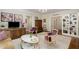 Bright living room with hardwood floors, built-in shelving, and elegant furniture at 1325 Peachtree Ne St # 401, Atlanta, GA 30309
