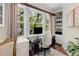 Bright office space featuring a large window with backyard view and built-in shelving and storage at 1325 Peachtree Ne St # 401, Atlanta, GA 30309