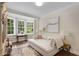 Bright sitting room with bay window, decorative rug, and cozy sofa at 1325 Peachtree Ne St # 401, Atlanta, GA 30309