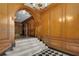 Grand staircase featuring marble steps, checkered flooring, and wood-paneled walls at 1325 Peachtree Ne St # 401, Atlanta, GA 30309