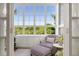 Cozy sunroom featuring large windows with natural light, comfortable seating, and built-in storage at 1325 Peachtree Ne St # 401, Atlanta, GA 30309