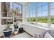 Bright sunroom with large windows, plants, and comfortable seating with views of the city at 1325 Peachtree Ne St # 401, Atlanta, GA 30309
