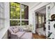 Cozy sunroom featuring large windows with natural light, comfortable seating, and access to dining room at 1325 Peachtree Ne St # 401, Atlanta, GA 30309