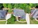 Aerial view of stunning home highlighting lush landscaping, large driveway, and pristine roof at 1875 Briergate Dr, Duluth, GA 30097