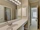 A bathroom vanity with a large mirror, storage, and excellent lighting at 1875 Briergate Dr, Duluth, GA 30097