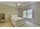 Serene bedroom featuring a ceiling fan and a large window with wooded views at 1875 Briergate Dr, Duluth, GA 30097
