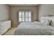Neutral bedroom featuring a white bed frame, dresser, and natural light at 1875 Briergate Dr, Duluth, GA 30097