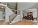 Spacious foyer featuring hardwood floors, a staircase, and a view of the dining room at 1875 Briergate Dr, Duluth, GA 30097