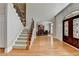 Elegant foyer with hardwood floors, staircase and decorative front door at 1875 Briergate Dr, Duluth, GA 30097