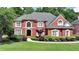 Stately red brick home with manicured landscaping and lush greenery, creating curb appeal at 1875 Briergate Dr, Duluth, GA 30097