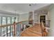 Second-floor hallway features hardwood floors, large windows, and wrought iron railing overlooking the living room at 1875 Briergate Dr, Duluth, GA 30097