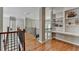 Upstairs landing with beautiful hardwood floors, custom bookshelves, and wrought-iron railing at 1875 Briergate Dr, Duluth, GA 30097