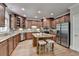 Spacious kitchen featuring custom wood cabinets, stainless steel appliances, and a granite-topped island with seating at 1875 Briergate Dr, Duluth, GA 30097