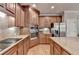 Modern kitchen with stainless steel appliances, granite counters, and warm wood cabinets provides a functional space at 1875 Briergate Dr, Duluth, GA 30097