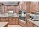 Gourmet kitchen showcasing stainless steel appliances, granite countertops, custom cabinetry, and hardwood flooring at 1875 Briergate Dr, Duluth, GA 30097