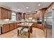 Well-appointed kitchen featuring wood cabinets, stainless steel appliances, granite countertops, and an island with breakfast bar at 1875 Briergate Dr, Duluth, GA 30097