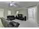 Cozy living room featuring neutral carpeting, ceiling fan and tv at 1875 Briergate Dr, Duluth, GA 30097