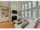 Elegant living room with a fireplace, custom built-ins, and a wall of windows at 1875 Briergate Dr, Duluth, GA 30097