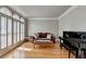 Comfortable living room with hardwood floors, shutters, and a grand piano at 1875 Briergate Dr, Duluth, GA 30097