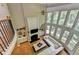 Bright living room with fireplace, built-ins, hardwood floors, and wall of windows at 1875 Briergate Dr, Duluth, GA 30097