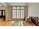 Relaxing living room featuring hardwood floors, shutters, and a cozy leather sofa at 1875 Briergate Dr, Duluth, GA 30097
