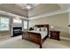 Comfortable main bedroom features a fireplace, tray ceiling, and carpet at 1875 Briergate Dr, Duluth, GA 30097