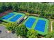 Overhead view of the tennis courts, including parking, shade structures and lush landscaping at 1875 Briergate Dr, Duluth, GA 30097