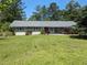 Charming single-story home with a well-maintained yard and a serene, tree-lined backdrop at 2291 Piney Grove Rd, Loganville, GA 30052