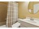 Well-lit bathroom with a shower/tub and modern sink with a large, round mirror at 4114 Suwanee Trail Dr, Buford, GA 30518