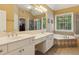 Luxurious bathroom with double sinks, a soaking tub, and a separate glass-enclosed shower at 4114 Suwanee Trail Dr, Buford, GA 30518