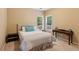 Inviting bedroom with a plush bed, side table, and desk by the windows showcases a serene retreat at 4114 Suwanee Trail Dr, Buford, GA 30518