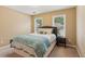 Cozy bedroom with a queen-size bed, soft bedding, and natural light from two windows at 4114 Suwanee Trail Dr, Buford, GA 30518