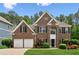 Charming two-story brick home featuring manicured landscaping, double garage and a welcoming entrance at 4114 Suwanee Trail Dr, Buford, GA 30518