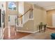 Bright foyer featuring hardwood floors, staircase with wood banister, and large arched window above doorway at 4114 Suwanee Trail Dr, Buford, GA 30518
