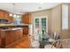 Eat in kitchen with hardwood floors, granite counters, stainless steel appliances and French doors at 4114 Suwanee Trail Dr, Buford, GA 30518