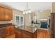 Open concept kitchen with granite counters, stainless appliances flowing into the adjacent living area at 4114 Suwanee Trail Dr, Buford, GA 30518