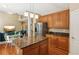 Kitchen island with hardwood floors, granite counters, and stainless steel appliances in open floor plan at 4114 Suwanee Trail Dr, Buford, GA 30518