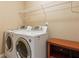Modern laundry room featuring a new washer and dryer and convenient shelving for storage at 4114 Suwanee Trail Dr, Buford, GA 30518