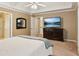 Beautiful bedroom suite features an entertainment center with a TV and neutral decor at 4114 Suwanee Trail Dr, Buford, GA 30518