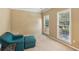 Cozy sitting area with two windows offers a relaxing space with a comfortable blue chair and ottoman at 4114 Suwanee Trail Dr, Buford, GA 30518