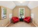 Bright sitting area with two red chairs and a window showcases a cozy, intimate space at 4114 Suwanee Trail Dr, Buford, GA 30518