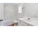 An all-white bathroom featuring a shower, toilet, and sink at 6397 Autumn View Nw Trce, Acworth, GA 30101