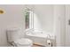 Bright bathroom featuring a soaking tub with window and a modern toilet at 6397 Autumn View Nw Trce, Acworth, GA 30101