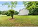 A house with a large green lawn, mature trees, and an outdoor grill at 6397 Autumn View Nw Trce, Acworth, GA 30101