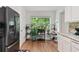 Bright kitchen featuring white cabinetry, stainless steel appliances, and a garden window at 6397 Autumn View Nw Trce, Acworth, GA 30101